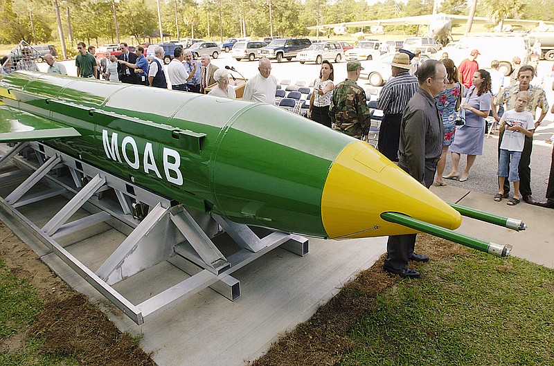 In this May 2004 photo, a group gathers around a GBU-43B, or massive ordnance air blast (MOAB) weapon, on display at Eglin Air Force Base near Valparaiso, Fla. U.S. forces in Afghanistan used one of these bombs for the first time to strike an Islamic State tunnel complex in eastern Afghanistan on Thursday. (Mark Kulaw/Northwest Florida Daily News via AP)