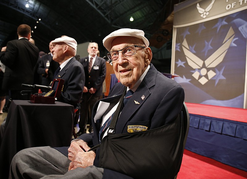 
              FILE – In this April 18, 2015, file photo, two members of the Doolittle Tokyo Raiders, retired U.S. Air Force Lt. Col. Richard "Dick" Cole, seated front, and retired Staff Sgt. David Thatcher, seated left, pose for photos after the presentation of a Congressional Gold Medal honoring the Doolittle Tokyo Raiders at the National Museum of the U.S. Air Force at Wright-Patterson Air Force Base in Dayton, Ohio. Cole, co-pilot of the Doolittle Tokyo Raiders’ lead plane and a fly-over by vintage B-25 bombers will be part of Ohio events April 17-18, 2017 for the 75th anniversary of the daring attack that helped turn the tide of World War II. Cole said it will be a somber moment when he toasts fellow Raider, Thatcher, who died in 2016. (AP Photo/Gary Landers, File)
            