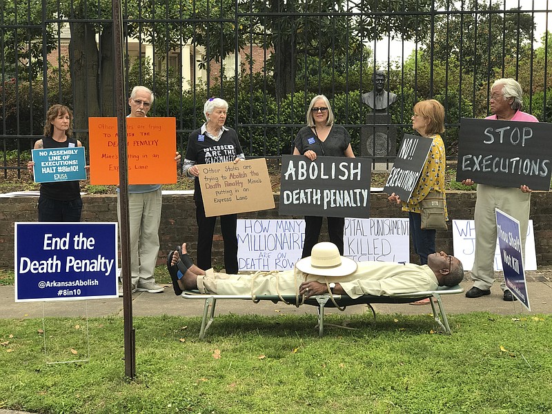 
              This photo provided by Sherry Simon shows Pulaski County Circuit Judge Wendell Griffen taking part of an anti-death penalty demonstration outside the Governor's Mansion Friday, April 14, 2017 in Little Rock, Ark.  Griffen issued a temporary restraining order Friday blocking the state from using its supply of vecuronium bromide after a company said it had sold the drug to the state for medical purposes, not capital punishment.   Local media outlets had tweeted photos and video of Griffen appearing to mimic an inmate strapped to a gurney at the demonstration.   Attorney General Leslie Rutledge's office said she planned to file an emergency request with the state Supreme Court to vacate Griffen's order, saying Griffen shouldn't handle the case.  (Sherry Simon via AP)
            