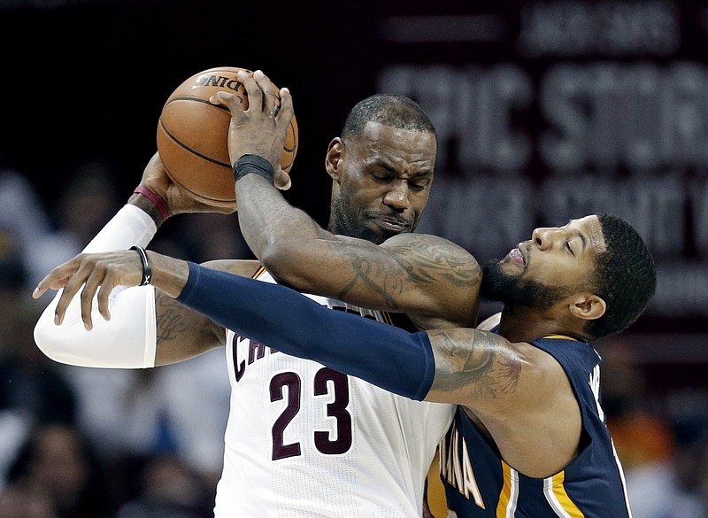 
              Indiana Pacers' Paul George, right, reaches in against Cleveland Cavaliers' LeBron James in the second half in Game 2 of a first-round NBA basketball playoff series, Monday, April 17, 2017, in Cleveland. The Cavaliers won 117-111. (AP Photo/Tony Dejak)
            