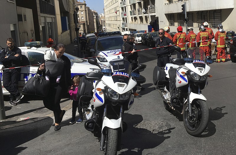 
              Police officers and rescue workers cordon off a street during searches in Marseille, southern France, Tuesday, April 18, 2017. French police thwarted an imminent "terror attack," arresting two suspected radicals Tuesday in the southern port city of Marseille, the interior minister said just days before the first round of France's presidential election. (AP Photo/Claude Paris)
            