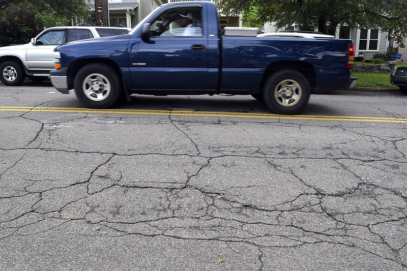 Cracks and potholes cover the weathered surface of East 10th Street at the intersection of Fairview Avenue.  AAA today is releasing a report detailing pavement conditions, congestion levels, highway safety data, and cost breakdowns for Chattanooga urban areas. on April 18, 2017.  