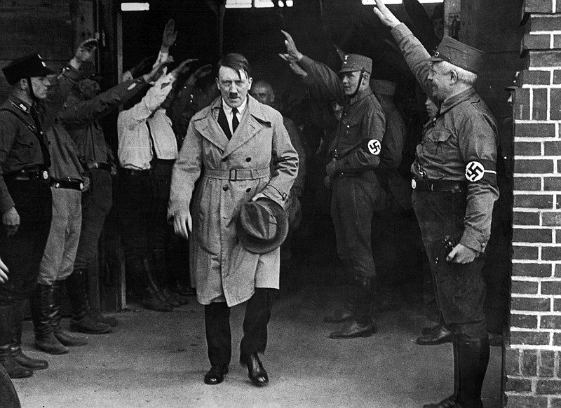 
              FILE - In this Dec. 5, 1931 file photo, Adolf Hitler, leader of the National Socialists, is saluted as he leaves the party's Munich headquarters. The book, "Human Rights After Hitler" by British academic Dan Plesch, says Hitler was put on the United Nations War Crimes Commission's first list of war criminals in December 1944, but only after extensive debate and formal charges brought by Czechoslovakia. Plesch, who led the campaign for open access to the commission's archive, told The Associated Press on Tuesday, April 18, 2017, that the documents show "the allies were prepared to indict Hitler as head of state, and this overturns a large part of what we thought we knew about him." (AP Photo, File)
            