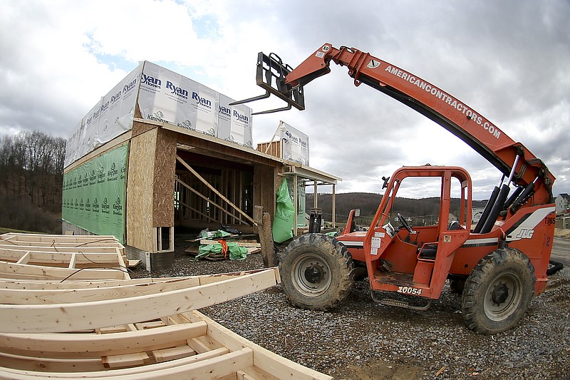 
              In this Wednesday, March 1, 2017, photo, made with a fisheye lens, a forklift is parked in front of one of the houses under construction in a housing plan in Zelienople, Pa. U.S. builders broke ground on fewer homes in March, but the pace of construction so far this year remains stronger than in 2016, according to information released Tuesday, April 18, 2017, by the Commerce Department. (AP Photo/Keith Srakocic)
            