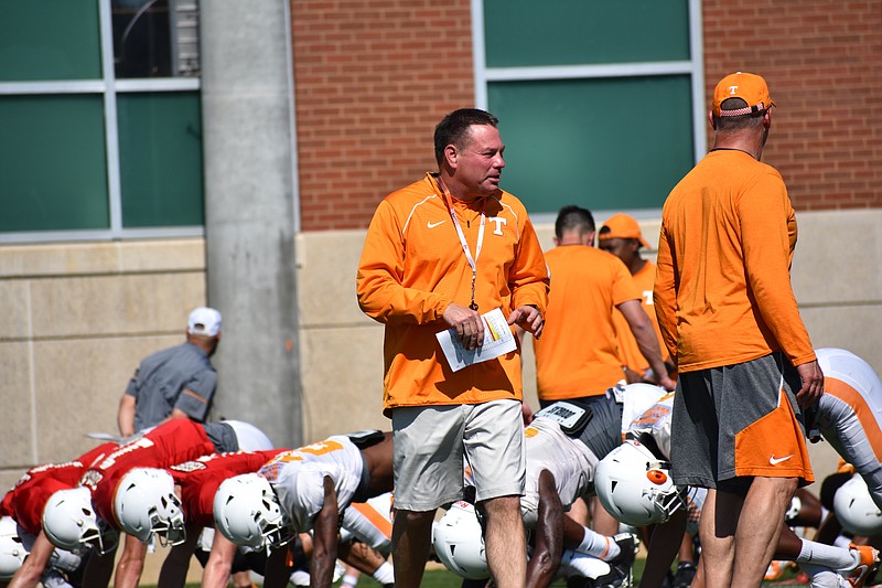 Tennessee coach Butch Jones walks through his team's stretching line before a practice at Haslam Field. Jones will be able to add a tenth assistant coach to his staff next season after new NCAA rules were approved last week in Indianapolis.