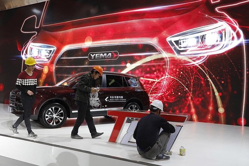 
              Workers prepare for the Auto Shanghai 2017 show at the National Exhibition and Convention Center in Shanghai, China, Tuesday, April 18, 2017. At the auto show, the global industry's biggest marketing event of the year, almost every global and Chinese auto brand is showing at least one electric concept vehicle, if not a market-ready model. (AP Photo/Ng Han Guan)
            