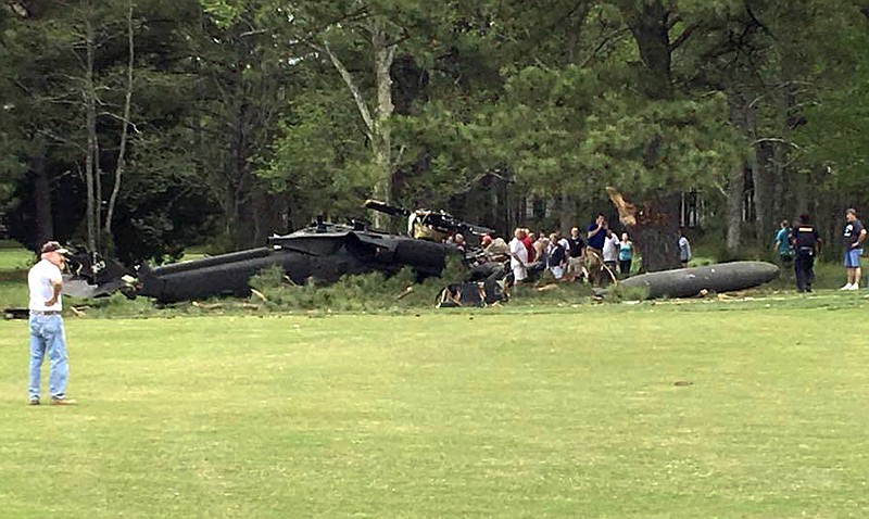 
              People examine an Army UH-60 helicopter from Fort Belvoir, Va., after it crashed at the Breton Bay Golf and Country Club after Monday, April 17, 2017, in Leonardtown, Md. (Rebecca Updegrave Cline via AP)
            