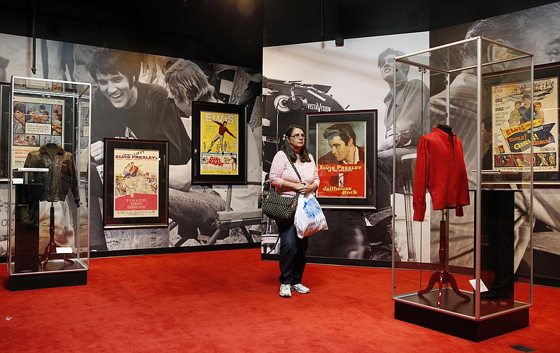 
              FILE - In this April 23, 2015 file photo, a woman tours an Elvis exhibition on the first day of "Graceland Presents Elvis: The Exhibition - The Show - The Experience" at the Westgate Las Vegas hotel in Las Vegas. Hundreds of Elvis Presley artifacts and memorabilia are still being held by a Las Vegas casino, a year after the King's estate filed a lawsuit to get those valuables back from a short-lived exhibit. (AP Photo/John Locher, File)
            