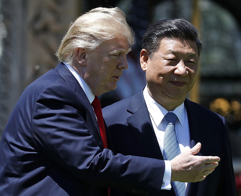 
              FILE - In this April 7, 2017, file photo, U.S. President Donald Trump gestures as he and Chinese President Xi Jinping walk together after their meetings at Mar-a-Lago in Palm Beach, Fla. After decades of failure to stop North Korea’s march toward a nuclear arsenal, some see Trump’s bluster as a shrewd attempt to press China, the North’s most important ally and trading partner, into pressuring North Korea more aggressively over its nuclear program. (AP Photo/Alex Brandon, File)
            