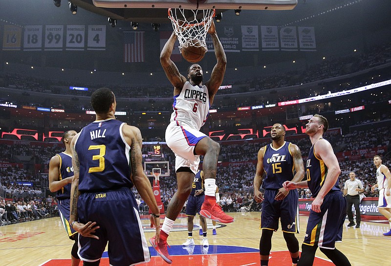 
              Los Angeles Clippers' DeAndre Jordan, center, dunks against the Utah Jazz during the first half in Game 2 of an NBA basketball first-round playoff series Tuesday, April 18, 2017, in Los Angeles. (AP Photo/Jae C. Hong)
            