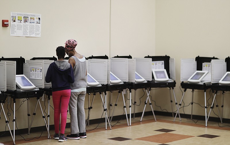 A voter casts a ballot in a special election in Atlanta, Tuesday, April 18, 2017. Republicans are bidding to prevent a major upset in a conservative Georgia congressional district Tuesday where Democrats stoked by opposition to President Donald Trump have rallied behind a candidate who has raised a shocking amount of money for a special election. (AP Photo/David Goldman)