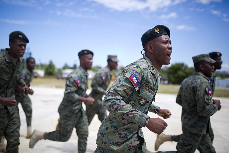 
              In this April 11, 2017 photo, members of Haiti's new national military force run and chant during training at a former U.N. base in Gressier, Haiti. As U.N. military peacekeepers prepare for a full exit from this Caribbean nation, Haiti is trying to revive a military force 22 years after a national army was disbanded. (AP Photo/Dieu Nalio Chery)
            