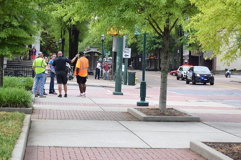 In this April 2017 file photo, a Chattanooga police officer talks with witnesses and bystanders at the scene of a collision between a pedestrian and a vehicle at the intersection of Market Street and Sixth Street. There was no information available from officials on the scene but a couple of bystanders said a woman was crossing Market Street in the northern crosswalk when she was struck.