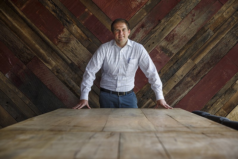 Staff photo by Doug Strickland / Attorney Robert Davis poses in front of a wall of reclaimed wood in the Davis, Kessler & Davis law firm on Cherokee Boulevard on Friday, April 14, 2017, in Chattanooga, Tenn. The firm is located in the old Pruett's grocery building, which has been renovated into offices and commercial space.