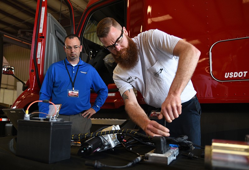 David Blankenship observes as James Teglas works during a diesel mechanic contest Thursday, April 20, 2017 at the U.S. Express Tunnel Hill Depot.