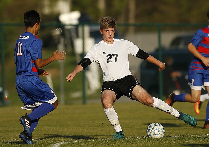Signal Mountain's Jonathan Miller (27) dribbles around Cleveland's Brian Ordonez during their prep soccer match at Signal Mountain Middle High School on Thursday, April 20, 2017, in Signal Mountain, Tenn.