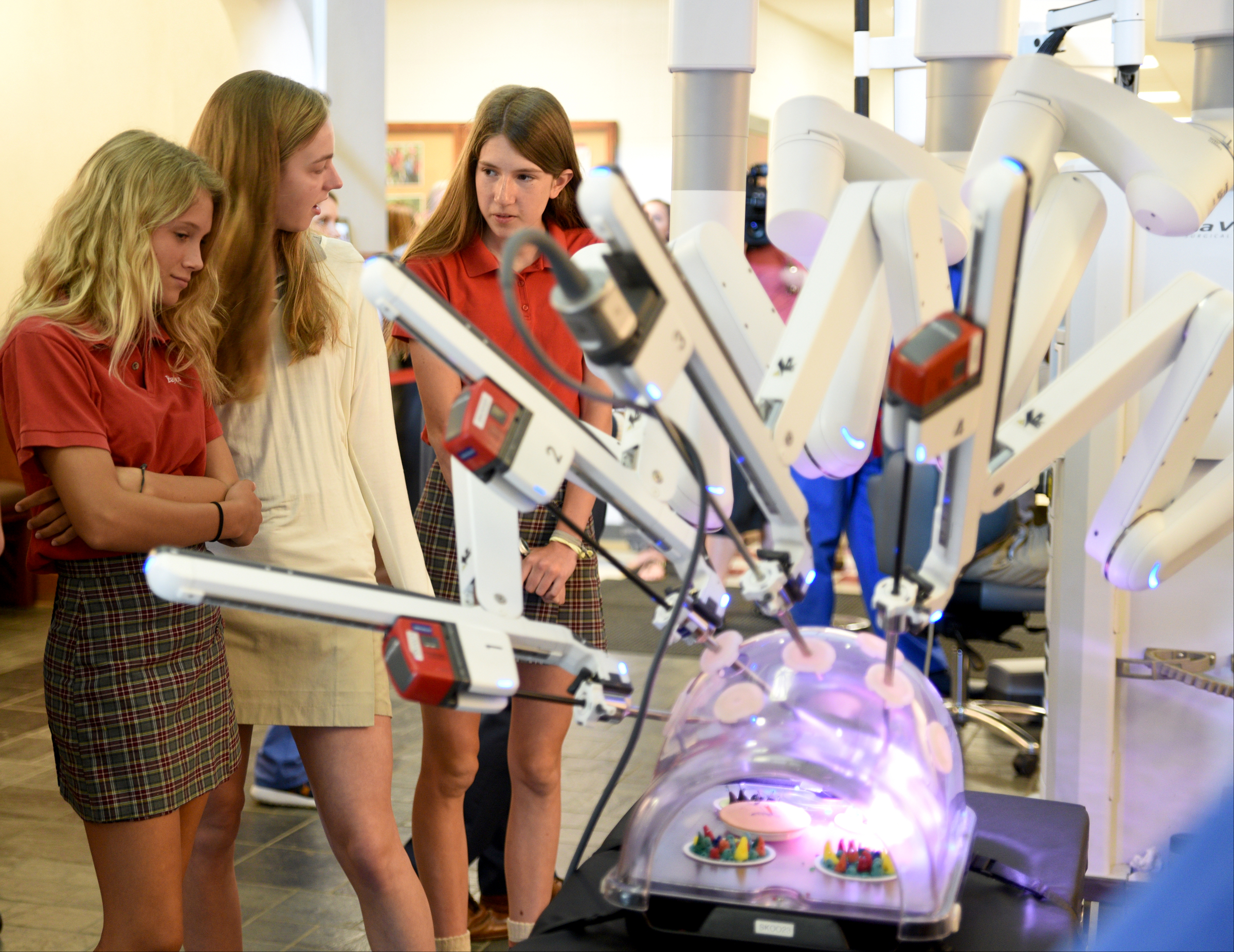 Anna Hawkins, Caroline Barker and Autumn Seymour, from left, watch a simulated procedure Thursday, April 20, 2017 at Baylor. Students had the opportunity to sit at the controls of the da Vinci Surgical System.