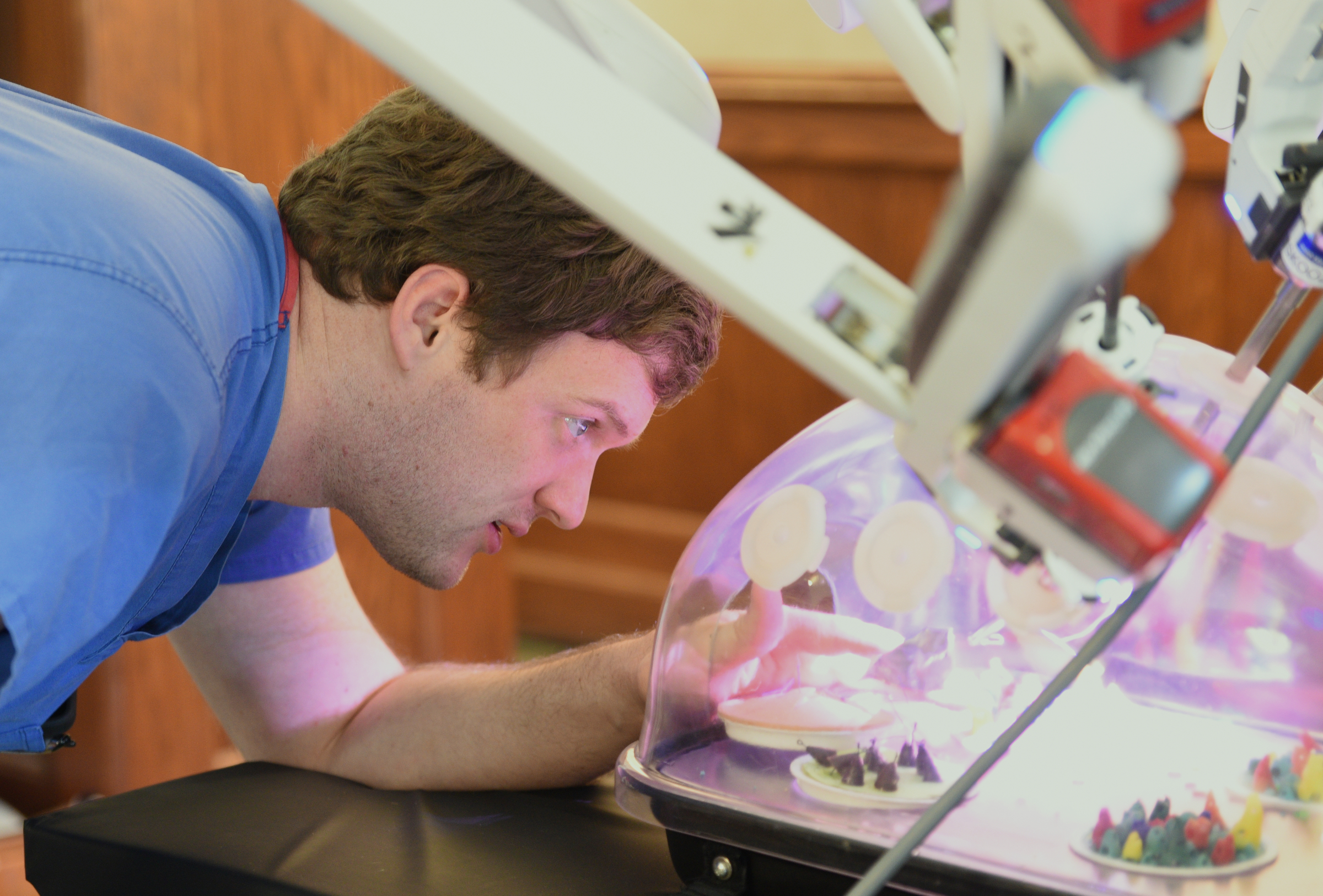 Surgery resident Steve Greer rearranges items so students can perform a simulated procedure with a da Vinci Surgical System Thursday, April 20, 2017 at Baylor.