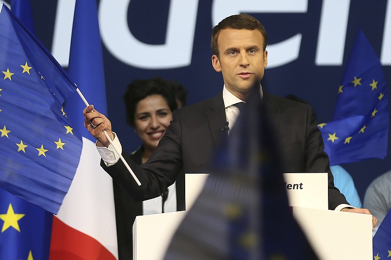 
              Independent centrist candidate Emmanuel Macron waves an European flag during a meeting in Nantes, western France, Wednesday, April 19, 2017. Polls suggest Macron has a good chance of coming out on top of Sunday's first round and reaching the May 7 runoff. (AP Photo/David Vincent)
            