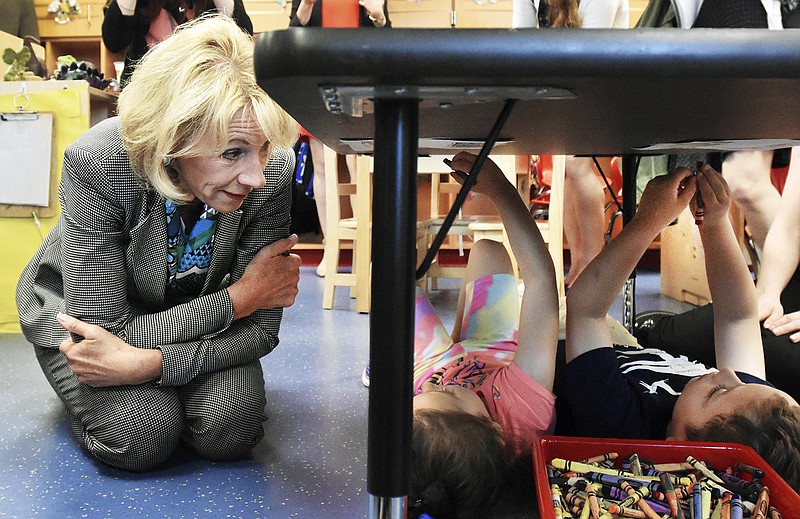 
              U.S. Education Secretary Betsy DeVos, left, talks with pre-k students Alivia, 5, and Kellen, 5, while visiting Laura Foster's class at the Van Wert Early Childhood Center, Thursday, April 20, 2017, in Van Wert, Ohio. American Federation of Teachers President Randi Weingarten joined DeVos during the visit. (Cathie Rowand/The Journal-Gazette via AP)
            
