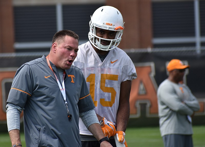 Tennessee coach Butch Jones and receiver Jajuan Jennings talk during practice this spring. The Vols will close their spring session with today's Orange and White Game at Neyland Stadium.