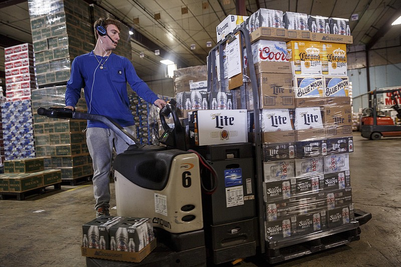 A worker uses a forklift as he fills an order at Carter Distributing on Broad Street on Wednesday, April 19, 2017, in Chattanooga, Tenn. Carter was recently recognized for its top Corona beer sales in 2016.