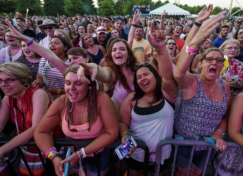 Fans cheer for Chris Lane as he performs on the 1st day of the Riverbend Festival at Ross's Landing on Friday, June 10, 2016, in Chattanooga, Tenn. The festival is celebrating its 35th year.