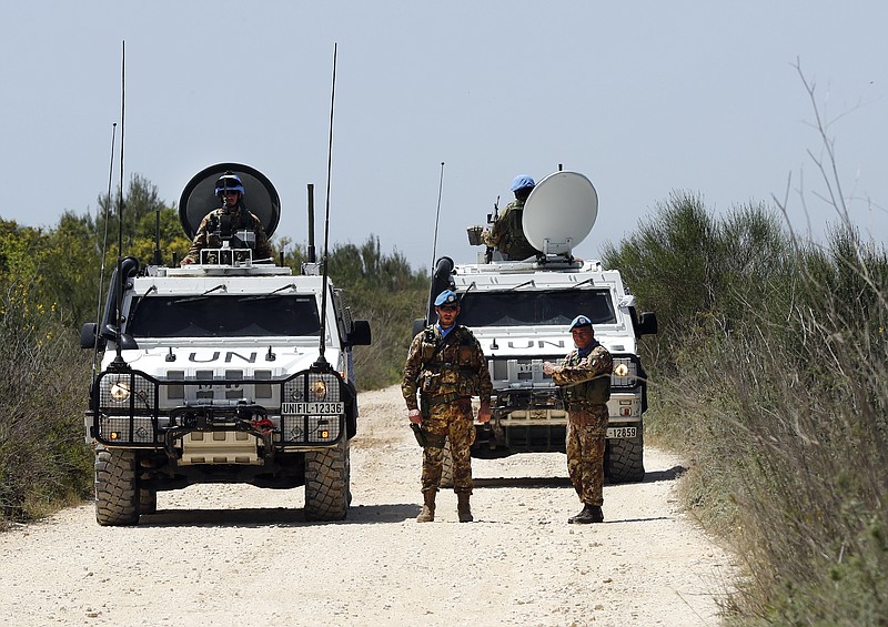 
              Italian UN peacekeepers watch journalists during a media trip organized by Hezbollah to show journalists the defensive measures established by the Israeli forces to prevent against any Hezbollah infiltration into Israel, at the Lebanese-Israeli border near the village of Labbouneh, south Lebanon, Thursday, April 20, 2017. Hezbollah organized a media tour along the border with Israel meant to provide an insight into defensive measures established by the Israeli forces along the southern frontier in the past year in preparation for any future conflict.(AP Photo/Hussein Malla)
            