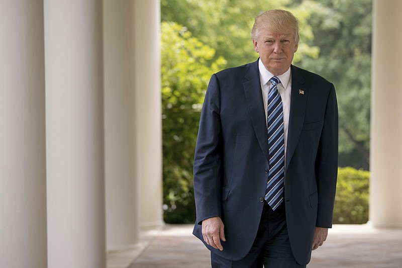 President Donald Trump walks along the West Wing Colonnade at the White House in Washington, Friday, April 21, 2017. Young immigrants brought to the U.S. illegally as children can "rest easy," the president said Friday, telling the "dreamers" they will not be targets for deportation under his immigration policies. Trump, in a wide-ranging interview with The Associated Press, said his administration is "not after the dreamers, we are after the criminals." (AP Photo/Andrew Harnik)