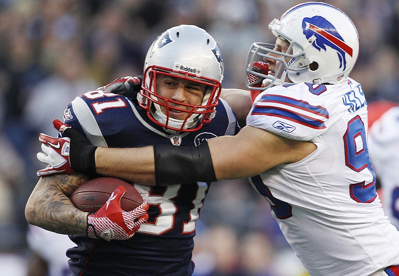 
              FILE - In this Sunday Jan. 1, 2012, file photo, New England Patriots tight end Aaron Hernandez (81) tries to break free of Buffalo Bills linebacker Chris Kelsay (90) during the fourth quarter of an NFL football game in Foxborough, Mass. Hernandez, who was serving a life sentence for a murder conviction and just days ago was acquitted of a double murder, died after hanging himself in his prison cell Wednesday, April 19, 2017, Massachusetts prisons officials said. (AP Photo/Elise Amendola, File)
            