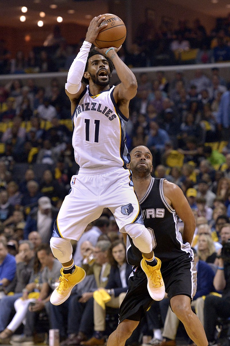 
              Memphis Grizzlies guard Mike Conley (11) shoots ahead of San Antonio Spurs guard Tony Parker during the first half of Game 4 in an NBA basketball first-round playoff series Saturday, April 22, 2017, in Memphis, Tenn. (AP Photo/Brandon Dill)
            