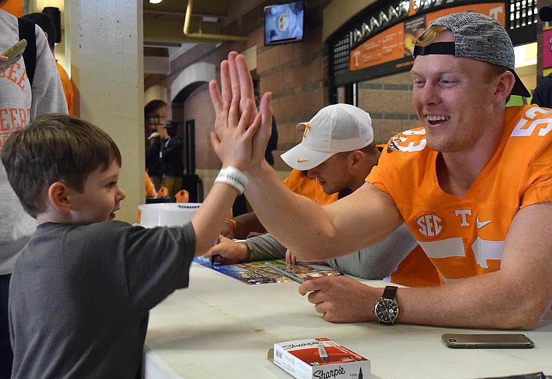 Lukas Marter gives a high five to fellow Chattanoogan Colton Jumper (53).  Fan day was moved inside to the concourse because of the rainy weather.  The annual Spring Orange and White Football game was held at Neyland Stadium on April 22, 2017.