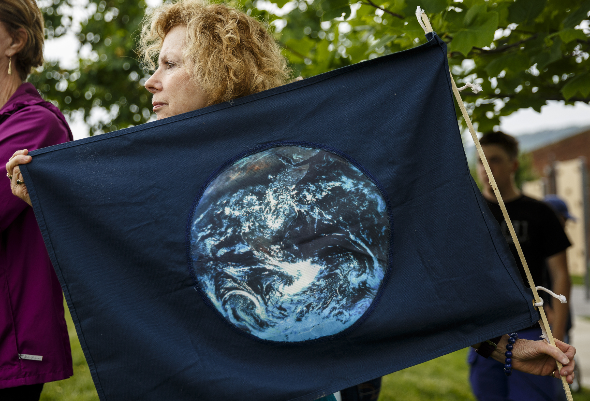 Judith Pedersen-Benn holds an earth flag in the Main Terrain Art Park during the March for Science on Saturday, April 22, 2017, in Chattanooga, Tenn. About a thousand demonstrators marched from the Main Terrain Art Park to Riverfront Parkway and back in support of science and education in solidarity with other marches nationwide.