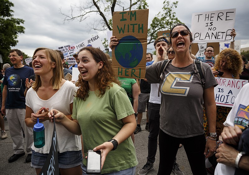 Demonstrators shout outside of the TDEC offices during the March for Science on Saturday, April 22, 2017, in Chattanooga, Tenn. About a thousand demonstrators marched from the Main Terrain Art Park to Riverfront Parkway and back in support of science and education in solidarity with other marches nationwide.