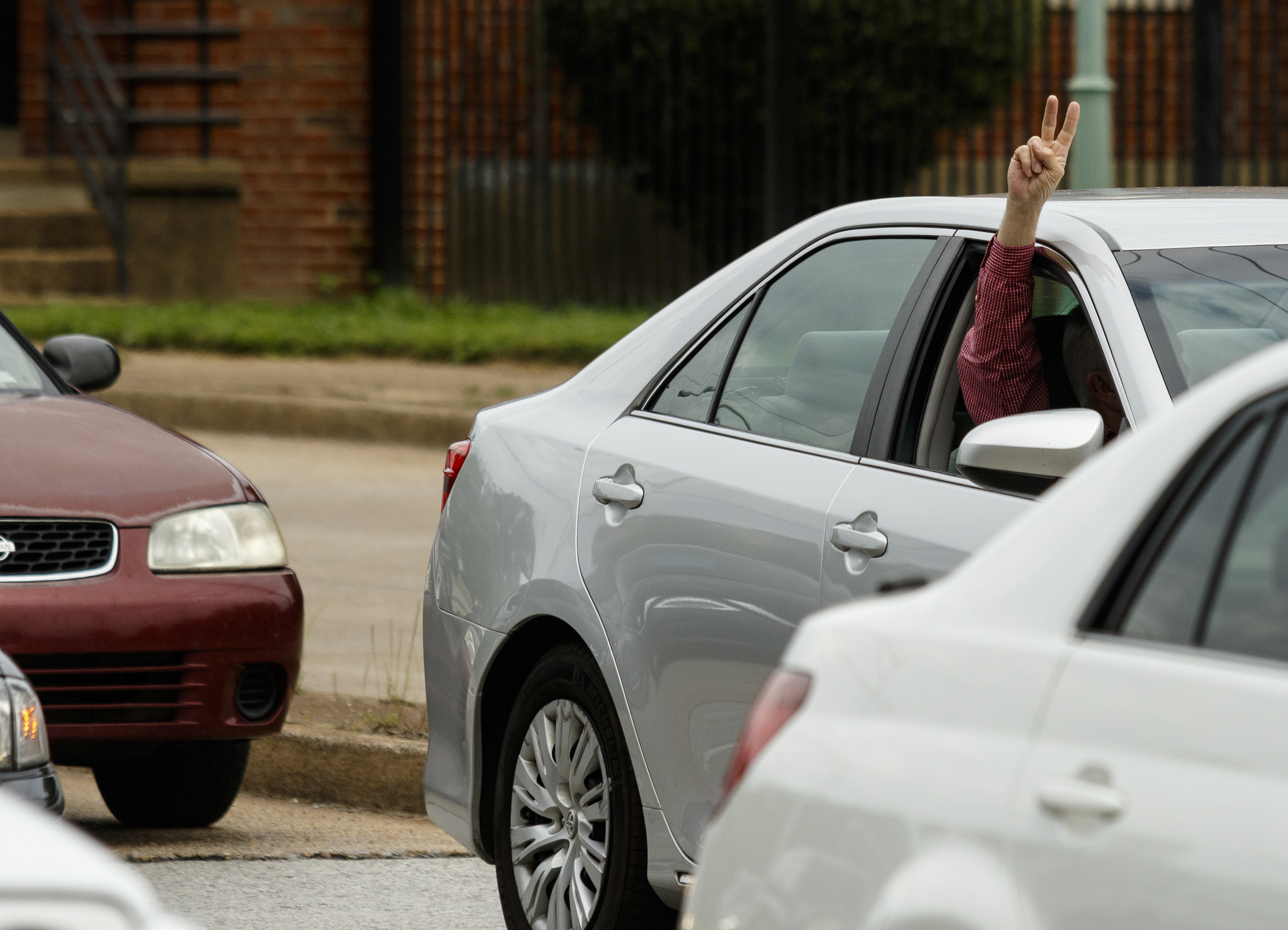A passenger in a stopped car holds up a peace sign as demonstrators block traffic on Riverside Drive during the March for Science on Saturday, April 22, 2017, in Chattanooga, Tenn. About a thousand demonstrators marched from the Main Terrain Art Park to Riverfront Parkway and back in support of science and education in solidarity with other marches nationwide.