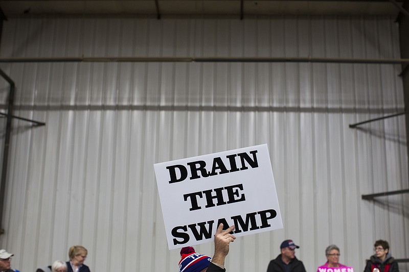 
              FILE - In this Oct. 27, 2016 file photo, supporters of then-Republican presidential candidate Donald Trump hold signs during a campaign rally in Springfield, Ohio. The Trump administration insists that “drain the swamp” is more than a throwaway catchphrase, yet in the last three months, the White House has become less transparent, hired scores of special interest players, raised money from lobbyists and taken no concrete steps to address campaign finance.  (AP Photo/ Evan Vucci, file)
            