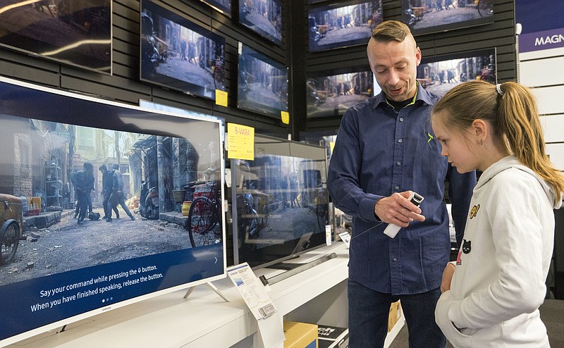 
              In this photo taken Saturday, April 15, 2017, Salome Sigurjonsdottir, 10, tests a voice-controlled television in an electronics store in Reykjavik. Sales assistant Einar Dadi said none of his TVs understood Icelandic. The revered Icelandic language, seen by many as a source of identity and pride, is being undermined by the widespread use of English both for mass tourism and in the voice-controlled artificial intelligence devices coming into vogue. (AP Photo/Egill Bjarnason)
            