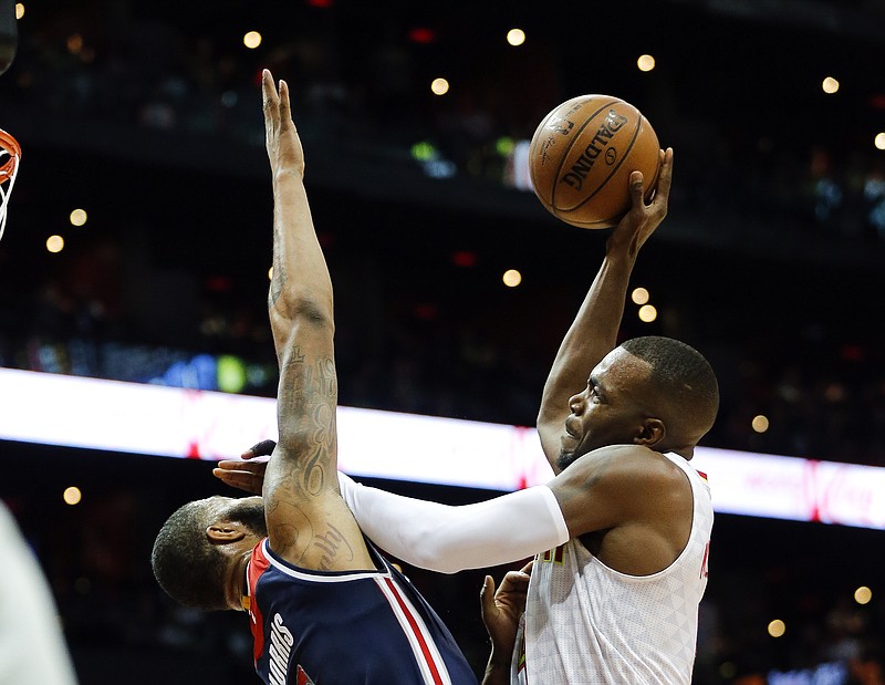 
              Atlanta Hawks forward Paul Millsap (4) goes to the basket against Washington Wizards forward Markieff Morris (5) during the first half of an NBA playoff basketball game Saturday, April 22, 2017, in Atlanta. (AP Photo/John Bazemore)
            