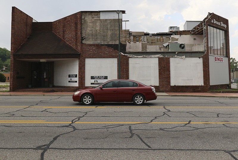 Staff Photo by Dan Henry / The Chattanooga Times Free Press- 4/20/17. Motorists pass the former LaDean Shop in Rossville on Thursday April 20, 2017, which has been vacant for some time and is now listed as for sale.
