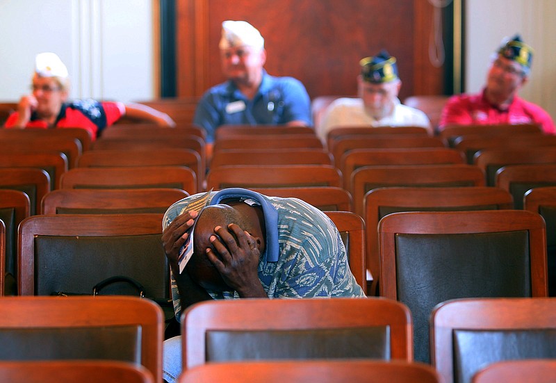 Veteran Clarence Graham holds his head in his hands after he spoke about the issues he has had getting the care he feels he needs from the Veterans Administration during a 2014 meeting hosted by the American Legion at the War Memorial in St. Louis.