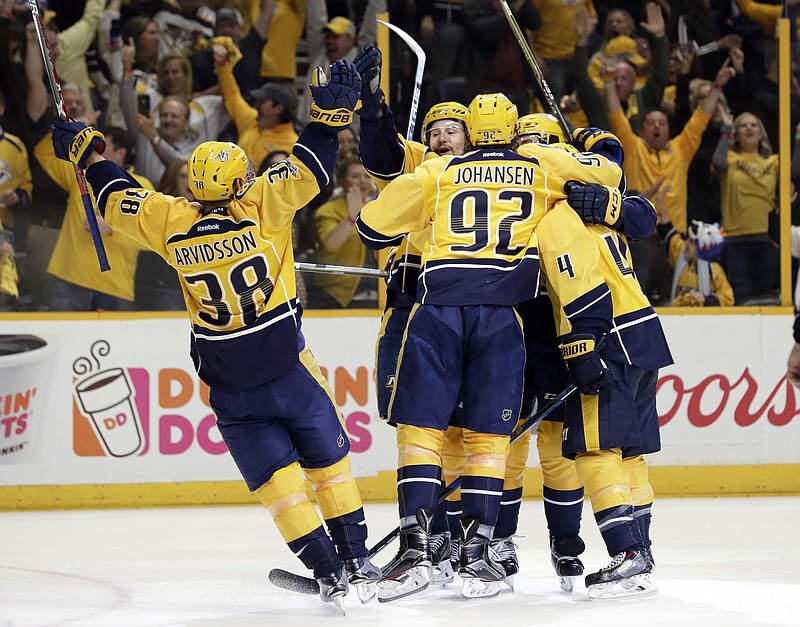
              Nashville Predators players celebrate after Roman Josi scored a goal against the Chicago Blackhawks during the second period in Game 4 of a first-round NHL hockey playoff series Thursday, April 20, 2017, in Nashville, Tenn. (AP Photo/Mark Humphrey)
            