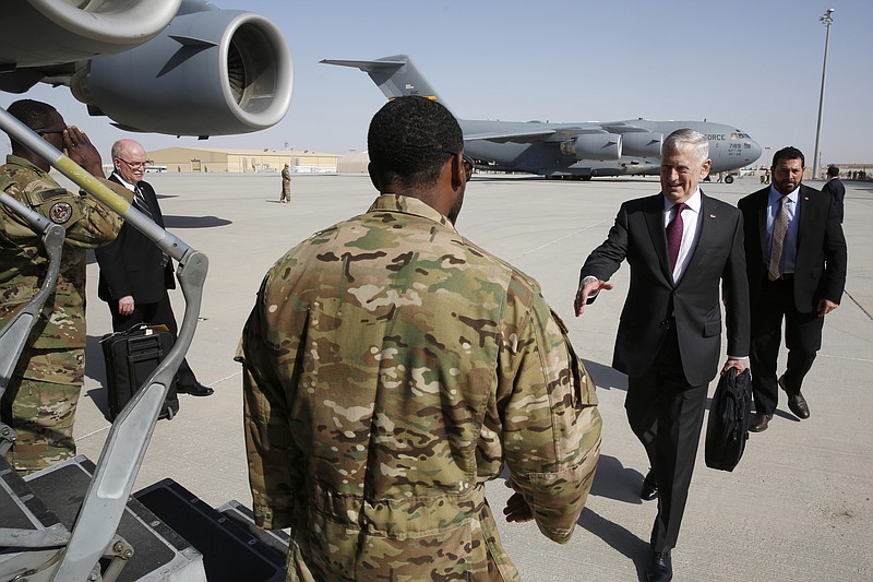 
              U.S. Defense Secretary James Mattis, second from right, greets an airman as he boards a U.S. Air Force C-17 Globemaster for a day trip to a U.S. military base in Djibouti from Doha, Qatar, Sunday, April 23, 2017. (Jonathan Ernst/Pool Photo via AP)
            