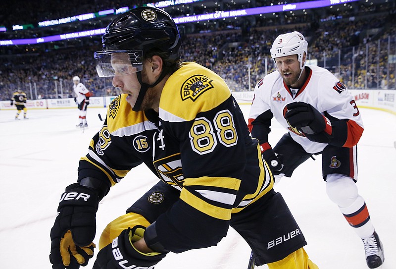 
              Boston Bruins' David Pastrnak (88), of the Czech Republic, and Ottawa Senators' Marc Methot (3) battle along the boards during the second period in Game 6 of a first-round NHL hockey Stanley Cup playoff series, Sunday, April 23, 2017, in Boston. (AP Photo/Michael Dwyer)
            