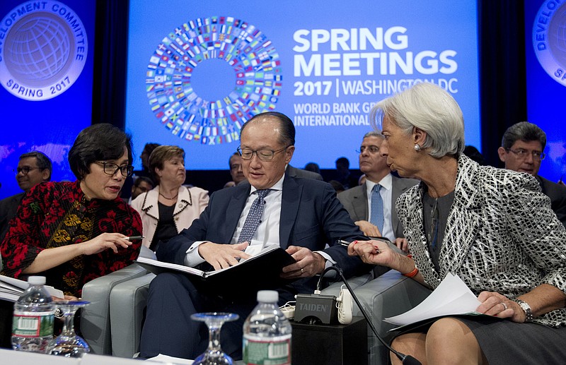 
              From left, Development Committee Chair and Indonesian Finance Minister Sri Mulyani Indrawati, World Bank President Jim Yong Kim, and International Monetary Fund (IMF) Managing Director Christine Lagarde confer before the Development Committee plenary during the World Bank/IMF Spring Meetings at IMF headquarters in Washington, on Saturday, April 22, 2017. (AP Photo/Jose Luis Magana)
            