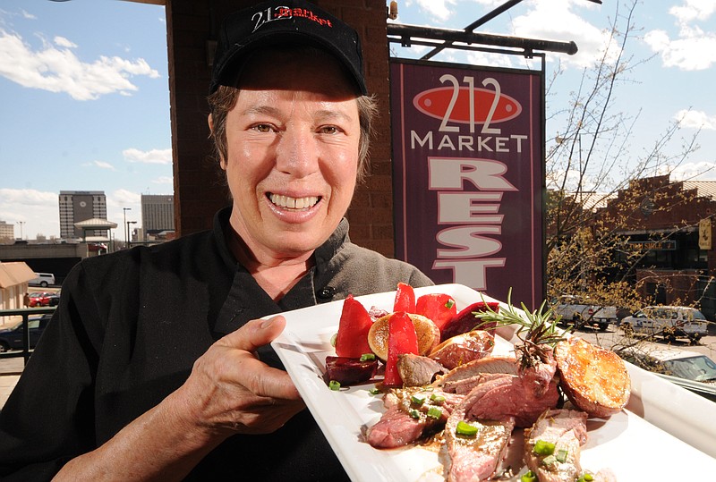 Susan Moses displays her Garlic and Rosemary Leg of Lamb for Easter at 212 Market in 2013.