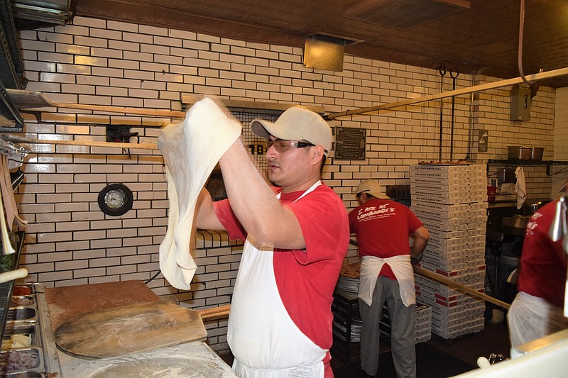 Dough stretchers prepare dough in Lombardi's kitchen.