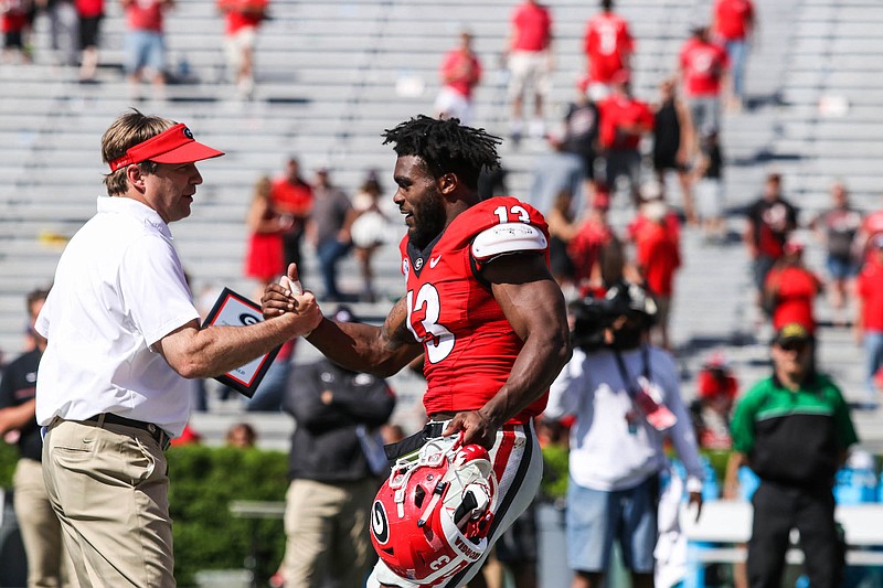 Georgia junior defensive end Jonathan Ledbetter receives congratulations from coach Kirby Smart during Saturday's G-Day game in Athens.