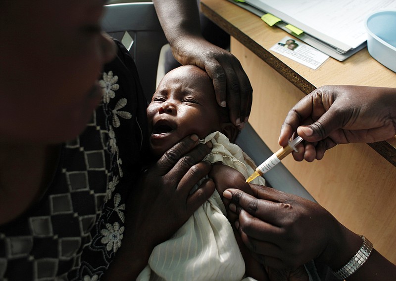 
              FILE - In this Oct. 30, 2009, file photo, a mother holds her baby receiving a new malaria vaccine as part of a trial at the Walter Reed Project Research Center in Kombewa in Western Kenya. The World Health Organization says three African countries have been chosen to test the world's first malaria vaccine. Ghana, Kenya and Malawi will begin piloting the injectable vaccine next year with young children. WHO said Monday, April 24, 2017, that the vaccine has the potential to save tens of thousands of lives if used with existing measures. The challenge is whether impoverished countries can deliver the required four doses of the vaccine for each child. (AP Photo/Karel Prinsloo, File)
            