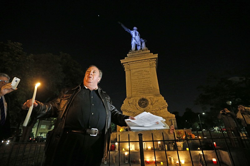 
              Charles Lincoln speaks during a candlelight vigil at the statue of Jefferson Davis in New Orleans, Monday, April 24, 2017. New Orleans will begin taking down Confederate statutes, becoming the latest Southern body to divorce itself from what some say are symbols of racism and intolerance. (AP Photo/Gerald Herbert)
            
