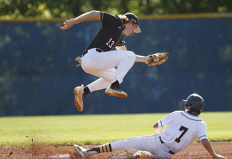 Signal Mountain shortstop Drew Lowry goes airborne as a bad throw gets CCS runner Nathaniel Kapp to 2nd during their prep baseball game at Chattanooga Christian School on Tuesday, April 25, 2017, in Chattanooga, Tenn. 